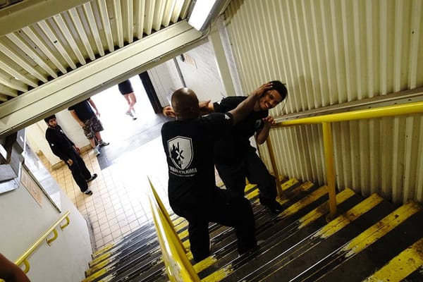 Practitioner navigating a chaotic stairwell/drill environment—symbolizing peace through chaos.